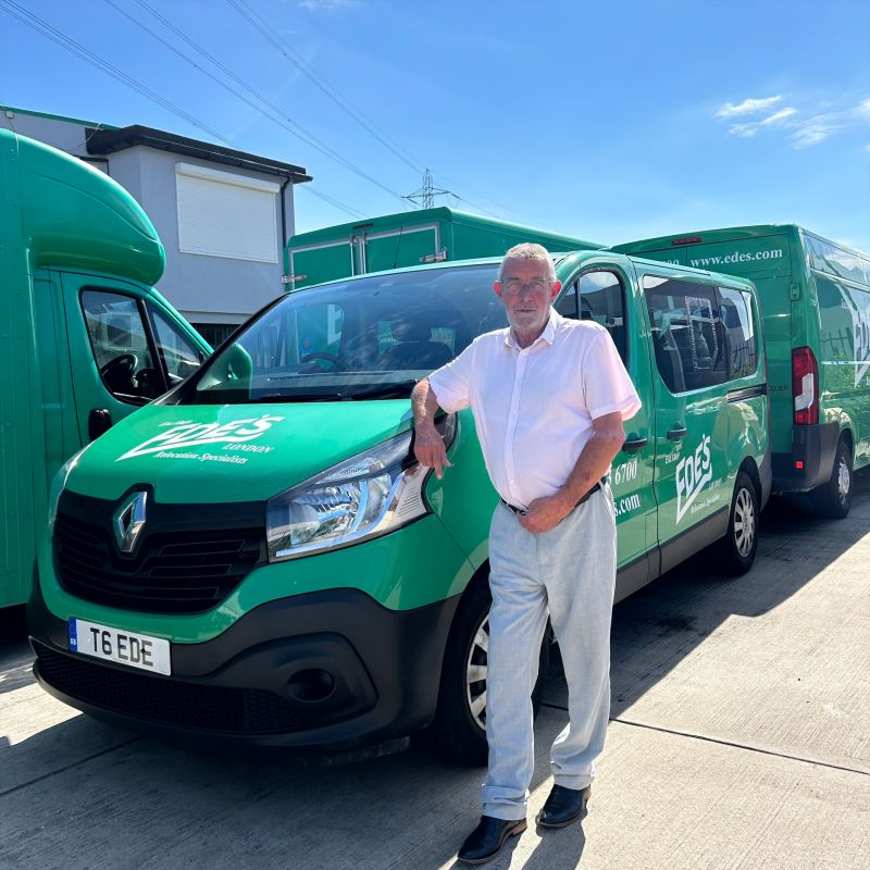 A man standing in front of two green vans, Congratulations to Andy Parker.