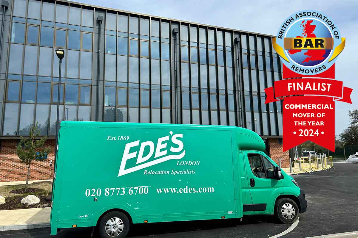 A green moving van labeled "ede's london commercial mover specialists" parked outside a modern building with a "finalist commercial mover of the year 2024" badge.
